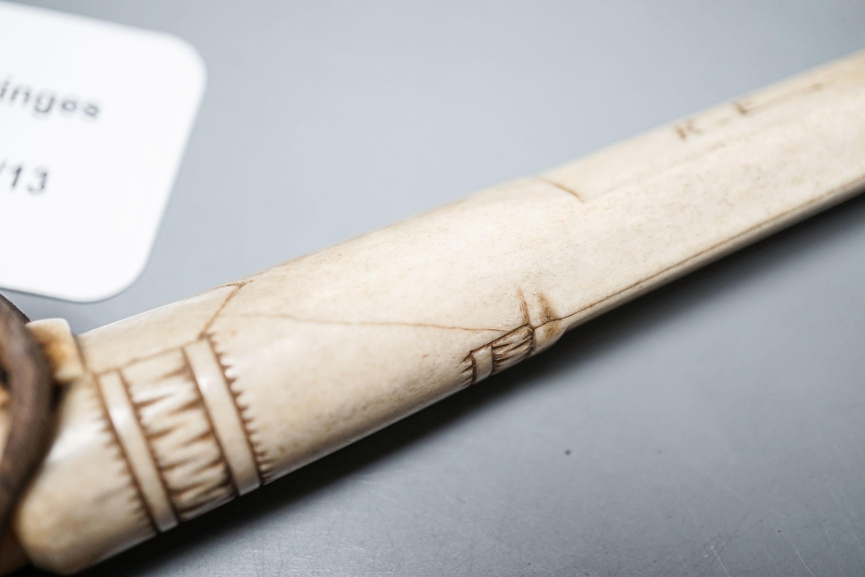 A 19th century Inuit carved stag antler dagger and scabbard, initialled ‘K.E’.